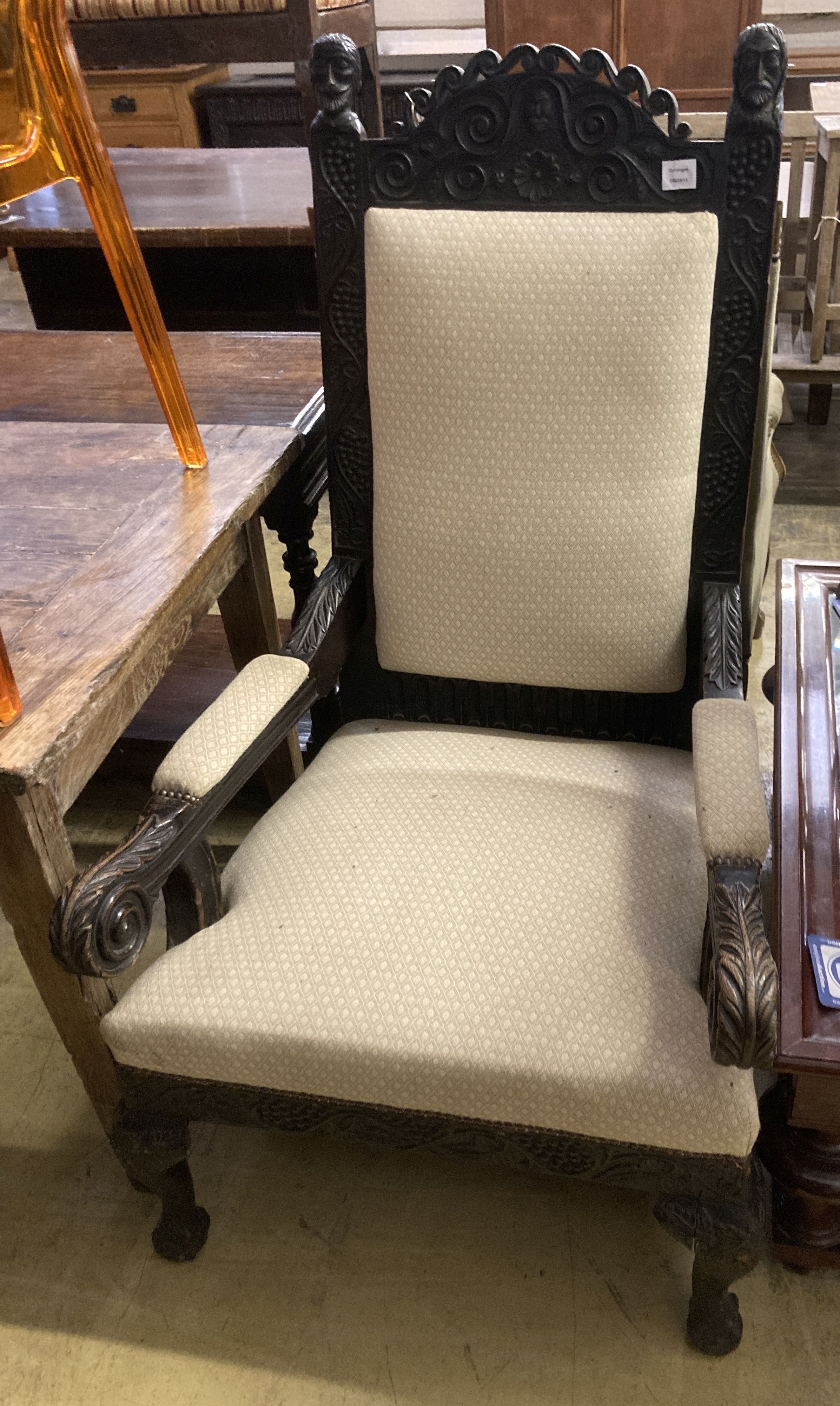 A Victorian Carolean design carved oak upholstered open armchair, width 68cm, depth 76cm, height 126cm